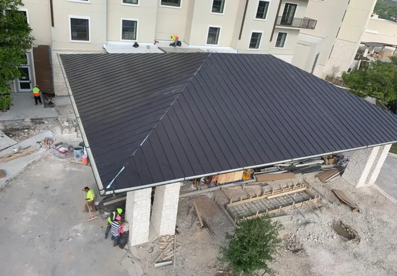 Metal roofing installation team working on a commercial building in Murphy